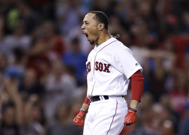 Standing just 5-foot-9, Red Sox outfielder Mookie Betts, shown after delivering a walk-off double to give Boston a win over the Cardinals on Wednesday night, had to overcome baseball's prejudice against short players before being signed.
