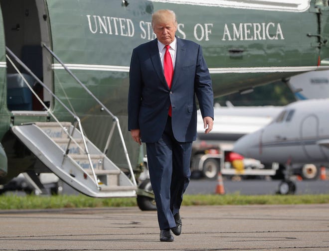 In this Aug. 14, 2017 file photo, President Donald Trump walks across the tarmac from Marine One to board Air Force One at Morristown Municipal Airport in Morristown, N.J. Bombarded by the sharpest attacks yet from fellow Republicans, President Donald Trump on Thursday, Aug. 17, 2017, dug into his defense of racist groups by attacking members of own party and renouncing the rising movement to pull down monuments to Confederate icons. (AP Photo/Pablo Martinez Monsivais, File)