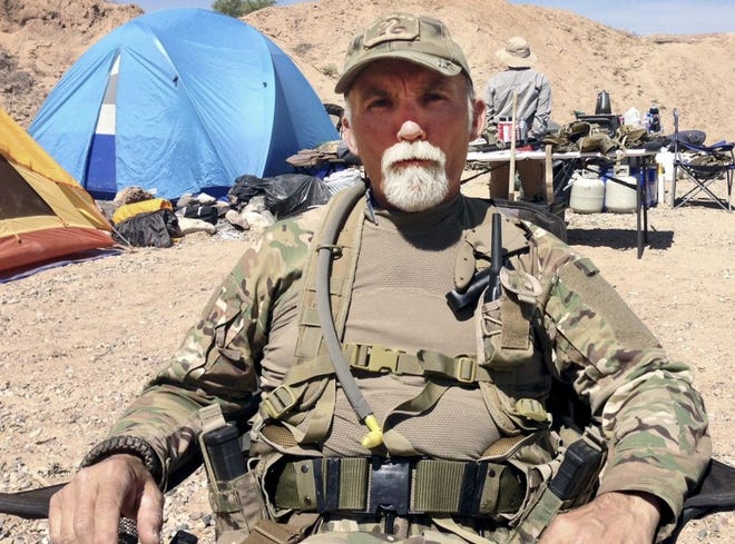 Gerald "Jerry" DeLemus of Rochester, sits among a group of militia members camping on Cliven Bundy's ranch near Bunkerville, Nev., in 2014.
[File photo/The Associated Press]