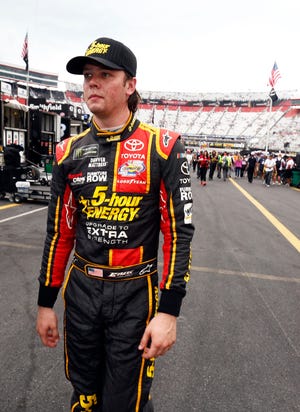 Erik Jones makes his way through the pit area after qualifying for a NASCAR Cup Series auto race, Friday, Aug. 18, 2017, in Bristol, Tenn. Jones will start on the pole for Saturday's race. (AP Photo/Wade Payne)