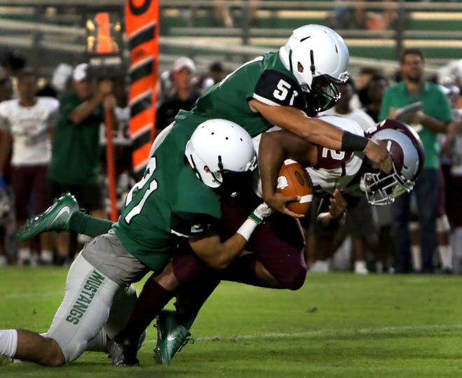 Riverview's Ali Boyce is brought down by Lakewood Ranch's Vinny Menno (21) and Michael Mellquist (51) during their Kickoff Classic on Friday night in Lakewood Ranch. [HERALD-TRIBUNE PHOTO / MATT HOUSTON]