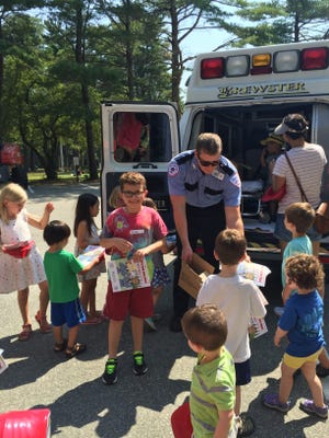 Evan Timothy, age 8, son of Kim and Nigel Timothy, enjoys a tour of ambulance as part of the MOMS Club of Sharon Community Hero Day on Thursday, August 10.

[Photo Courtesy of MOMS Club of Sharon]
