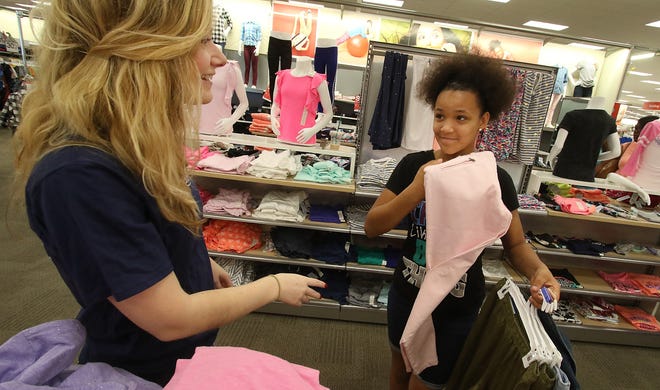 Gaston County Jaycees teamed up withThe Erwin Center and went back to school shopping at Target on Cox Road early Saturday morning in Gastonia. Here, volunteer Taylor Park shops for tops with Renee Jennings. [Mike Hensdill/The Gaston Gazette]