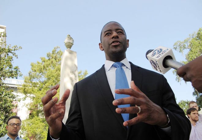 Tallahassee Mayor and Democratic candidate for governor Andrew Gillum stands in front of a Confederate monument on the Florida Capitol grounds and calls for its removal Saturday in Tallahassee.