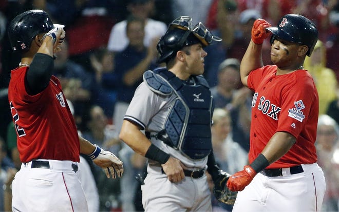 Red Sox third baseman Rafael Devers (right) celebrates his two-run home run that scored Xander Bogaerts during Boston's 9-6 win over the New York Yankees on Friday. [AP Photo/Michael Dwyer]