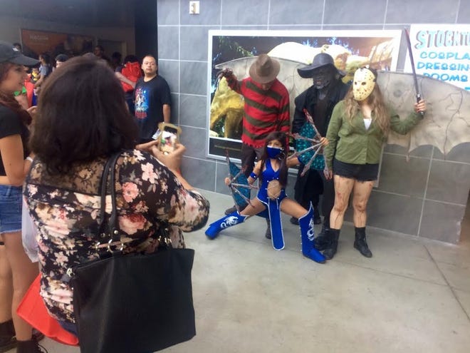 A group poses as people gather to take their photos during the sixth annual StocktonCon on Saturday at Stockton Arena. [ALMENDRA CARPIZO/THE RECORD]