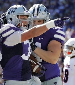 Kansas State fullback Winston Dimel, left, celebrates one of his 12 rushing touchdowns last season, sharing team-high honors with quarterback Jesse Ertz. “If he wasn’t a good football player or if he wasn’t a good runner, we wouldn’t do it,” K-State offensive coordinator Dana Dimel said of calling his son's number near the goal line “If he got in there and he didn’t have success and he wasn’t effective, we sure as heck wouldn’t do it."