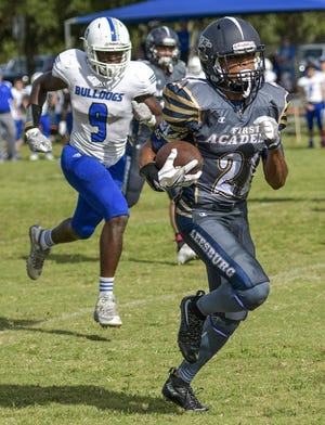 First Academy's Kanyon Walker (21) scores a touchdown at a game between First Academy of Leesburg and Mount Dora Christian Academy in Leesburg on Oct. 8, 2016. [PAUL RYAN / CORRESPONDENT]