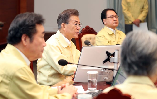 South Korean President Moon Jae-in, center, presides over a cabinet meeting at the presidential Blue House in Seoul, South Korea, Monday, Aug. 21, 2017. U.S. and South Korean troops have begun annual drills that come after tensions rose over North Korea's two intercontinental ballistic missile tests last month. Moon said Monday the drills are defensive in nature. He says the drills are held regularly because of repeated provocations by North Korea. (Kim Ju-hyung/Yonhap via AP)