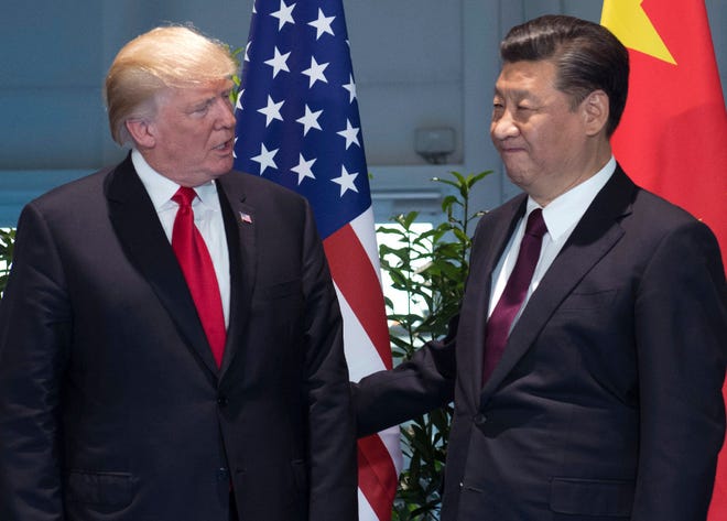 In this July 8, 2017, file photo, U.S. President Donald Trump, left, and China's President Xi Jinping arrive for a meeting on the sidelines of the G-20 Summit in Hamburg, Germany.