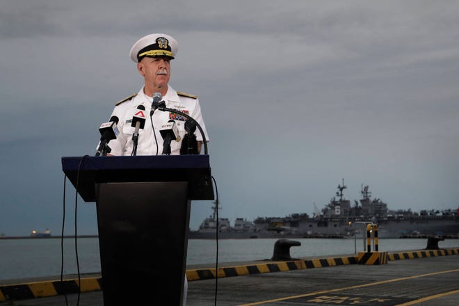 Commander of the U.S. Pacific Fleet, Scott Swift, answers questions during a press conference with the USS John S. McCain and USS America docked in the background at Singapore’s Changi naval base on Tuesday, Aug. 22, 2017, in Singapore. The focus of the search for 10 U.S. sailors missing after a collision between the USS John S. McCain and an oil tanker in Southeast Asian waters shifted Tuesday to the damaged destroyer’s flooded compartments. (AP Photo/Wong Maye-E)