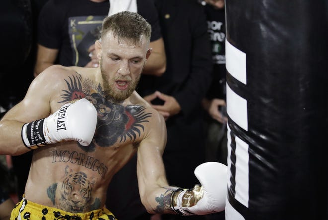 Conor McGregor trains during a media workout Friday in Las Vegas. McGregor is scheduled to fight Floyd Mayweather Jr. in a boxing match Saturday in Las Vegas. [AP Photo / John Locher]