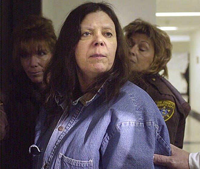 FILE - In this Jan. 20, 2004 file photo, Marjorie Diehl-Armstrong heads into a hearing at the Erie County Courthouse in Erie, Pa. Mark Marvin, who claims to have been her common law husband of Marjorie Diehl-Armstrong, who was convicted in a bank robbery plot that killed a man forced to wear a collar bomb, has asked federal prison officials to release her remains to him and confirm her April 4, 2017, death at a prison hospital in Texas. (Janet B. Campbell/Erie Times-News via AP, File)