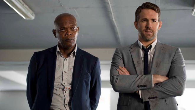 This image released by Lionsgate shows Samuel L. Jackson, left, and Ryan Reynolds in "The Hitman’s Bodyguard." (Jack English/Lionsgate via AP)