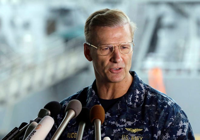 In this June 18, 2017, file photo, U.S. Navy Vice Adm. Joseph Aucoin, Commander of the U.S. 7th Fleet, speaks during a press conference, with damaged USS Fitzgerald as background at the U.S. Naval base in Yokosuka, southwest of Tokyo. U.S. officials said that Aucoin is to be relieved of duty after series of ship accidents in the Pacific. (AP Photo/Eugene Hoshiko, File)
