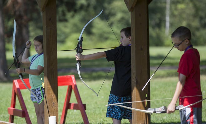 From left: Zoe McCachren, 10, of New Florence, Zach McCachren, 12, of New Florence and Cameron Sismondo, 12, of Washington, Pa., prepare to shoot arrows during an archery activity Saturday at Camp Wakchazi, a camp for children coping with the loss of a sibling, at Camp Kon-O-Kwee Spencer YMCA in Marion Township. The camp offered fun activities while encouraging campers to heal with others.