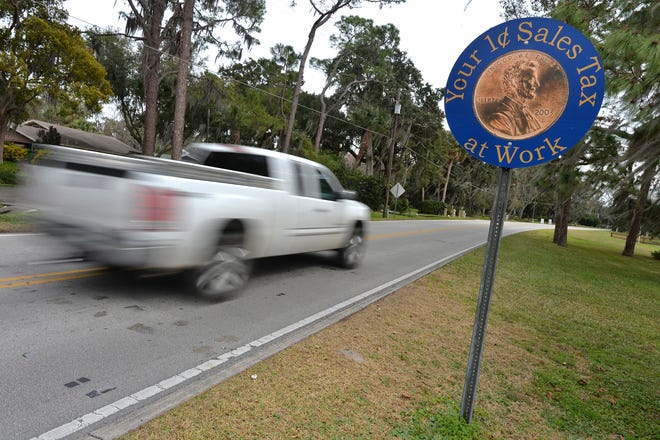A truck passes the penny sales tax sign on Lakeshore Drive in Mount Dora on Wednesday, Feb. 12, 2014. [BRETT LE BLANC / DAILY COMMERCIAL]