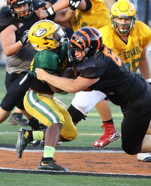Massillon's Lucas McGuire works to bring down St. Edward's Jordan Castleberry during their scrimmage.

 (IndeOnline.com / Kevin Whitlock)