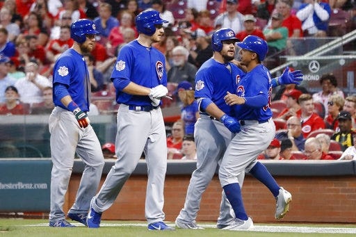 Chicago’s Kyle Schwarber, third from left, celebrates with Jon Jay, right, Mike Montgomery, second from left, and Ben Zobrist after hitting a three-run home run in the fourth inning Wednesday at Great American Ball Park. [John Minchillo/The Associated Press]