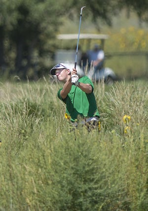 Pueblo County High School golfer, Andrew Egan, watches his second shot from the weeds land on the green while playing in the Centennial Invitational Wednesday morning August 23, 2017 at Walking Stick Golf Course in Pueblo, Colo.