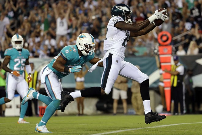 Eagles receiver Alshon Jeffery scores a touchdown past Dolphins defensive back Nate Allen during the first half in Philadelphia on Thursday, Aug. 24, 2017.
