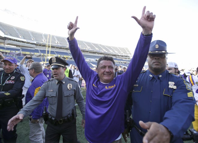 LSU football coach Ed Orgeron celebrates after leading the Tigers to a 29-9 win over Louisville in the Buffalo Wild Wings Citrus Bowl on Dec. 31 in Orlando, Fla. [AP file]