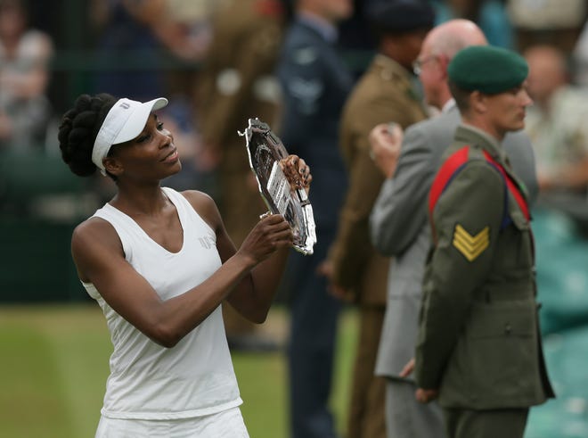 This July 15, 2017, file photo shows Venus Williams of the United States holding the runners-up plate after losing to Spain's Garbine Muguruza in the Women's Singles final match at the Wimbledon Tennis Championships in London.