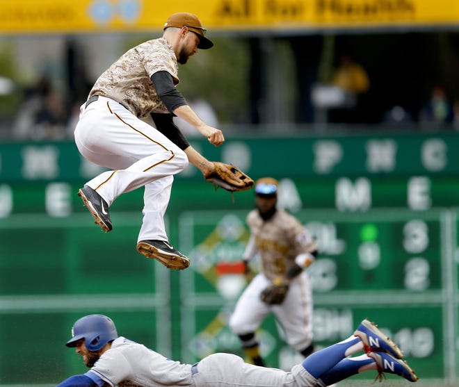 Pittsburgh Pirates shortstop Jordy Merce, left leaps for thr throw as Los Angeles Dodgers' Chris Taylor steals second base in the second inning of the Pirates' loss Thursday in Pittsburgh.