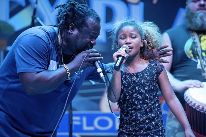 Jacksonville's De Lions of Jah featuring vocalist Dave "Da General" Philip, shown onstage with his daughter Jazzie, will perform in this week's "Free Fridays" concert at Bo Diddley Plaza from 8-10 p.m. Friday. The performance is a makeup date for the group's washed out appearance in June. [Suzanna Mars/Submitted photo]
