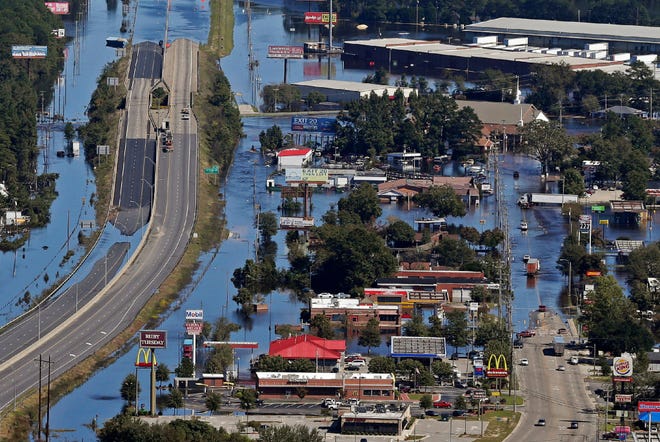 Floodwaters from Hurricane Matthew covers parts of Interstate 95 and homes and businesses in Lumberton, N.C., Wednesday, Oct. 12, 2016.