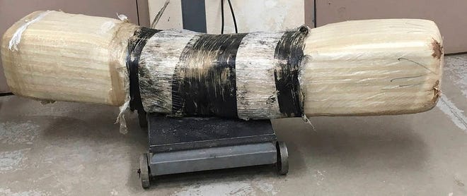 This undated photo provided by Customs and Border Protection shows a 100-pound bundle of marijuana. Border Patrol agents in southern Arizona have seized a nearly 100 pounds of marijuana after spotting it flying over the border fence. (Customs and Border Protection via AP)