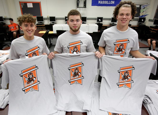 Washington High School DECA students are selling T-shirts for the week 2 matchup against GlenOak on Sept. 1. Students Alex Berbari, from left, Desean McElroy, and Neil Huth helped design and market the shirts as part of DECA project used at DECA competitions.

(IndeOnline.com / Kevin Whitlock)