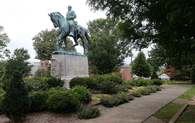 In this photo taken Aug. 14, 2017, the statue of Confederate Gen. Robert E. Lee still stands in Lee Park in Charlottesville, Va.