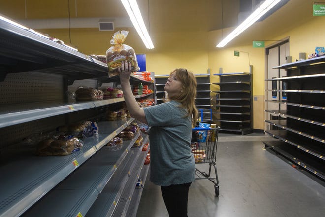 Kim Meyer looks to stock up on bread while shopping for supplies at a Walmart in Victoria, Texas, Thursday, Aug. 24, 2017, in preparation for Hurricane Harvey to make landfall in southeast Texas. (Nicolas Galindo/The Victoria Advocate via AP)