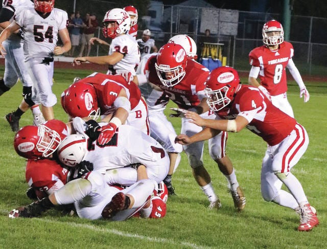 Vince Castillo, Spencer Turner, Tyler Casotti and Mason Hulse gang tackle a Creston ball carrier during Friday’s season-opening victory. Photo by Andrew Logue/News-Republican