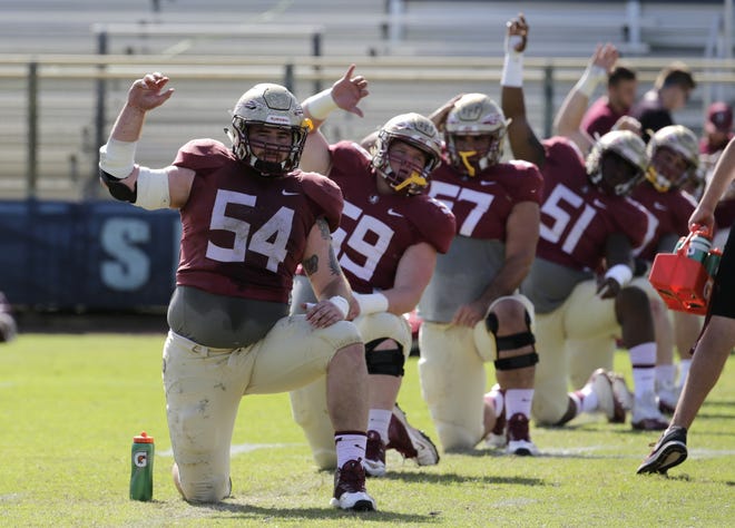 Florida State offensive lineman Alec Eberle (54) stretches during practice on Dec. 27, 2016, in Fort Lauderdale. Most who watched Florida State last season thought QB Deondre Francois was the team's toughest players for the hits that he took. It ended up being center Alec Eberle, who kept playing despite two labral tears in his hip. A healthy Eberle could be the key to an offensive line that has struggled the past two seasons. [AP Photo / Lynne Sladky, File]