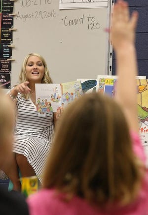 First-grade teacher Reagan Cleveland reads a book to her class in August 2016. K-3 classrooms will be smaller this year per new state policy. [Mike Hensdill/The Gaston Gazette]