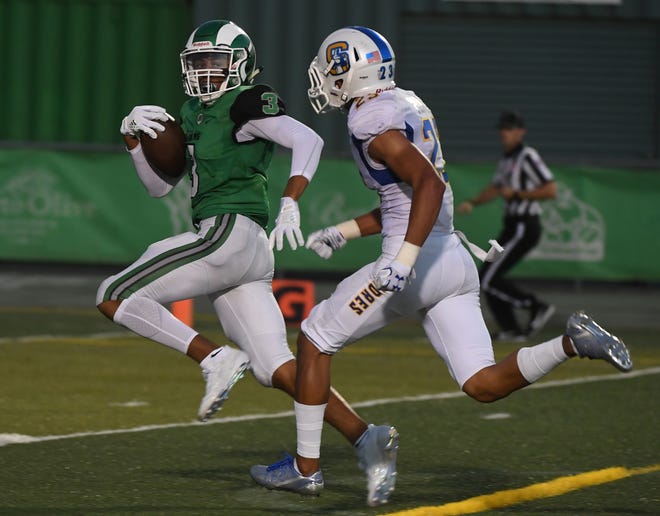 St. Mary's sophomore Jamar Marshall, left, runs past Serra's Chris Park to cap his 56-yard touchdown reception from sophomore quarterback Noah May during their season opener on Saturday at Sanguinetti Field in Stockton. [CALIXTRO ROMIAS/THE RECORD]