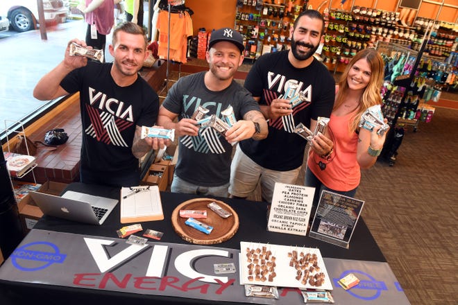 Jerry Patterson, left, Nathan Flood, Gabe DeAnda and Chelsey Bell hold energy bars at a display of VICIA Energy Bars inside Fleet Feet in Stockton. The nutrient-packed bars have gone from selling out at farmers markets and coffee shops to attracting the interest of major grocery stores, and the fitness enthusiasts behind the snacks are hoping a Kickstarter campaign helps take themto the next level.

[CALIXTRO ROMIAS/THE RECORD]