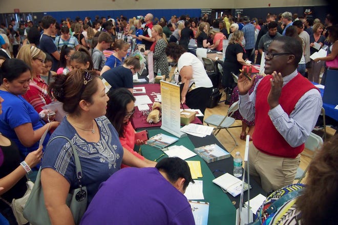 Milford Miles, a field representative from the University of San Francisco, speaks with parents and students at last year's Lodi Unified College and Career Night. This year's event is Monday. [CALIXTRO ROMIAS/RECORD FIILE 2016]