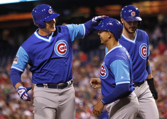 The Cubs' Anthony Rizzo, left, is cheered by Jon Jay, center, and Kris Bryant after hitting a three-run home run in the third inning of their team's 17-2 win over the Phillies Saturday night in Philadelphia. [LAURENCE KESTERSON/THE ASSOCIATED PRESS]