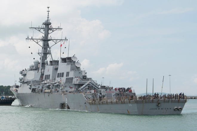The guided-missile destroyer USS John S. McCain (DDG 56) steers towards Changi Naval Base, Singapore, following a collision with the merchant vessel Alnic MC while underway east of the Straits of Malacca and Singapore.