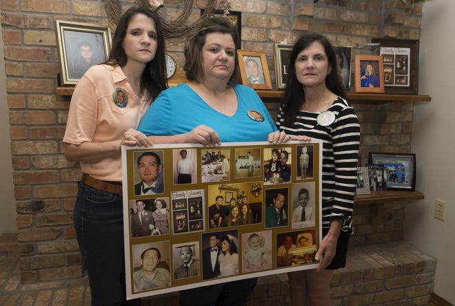 Monica Breaux Larpenter (from left), Tania Breaux Guidry and Melissa Breaux Tardo pose Friday at Larpenter's home in Houma with a photo collage of their father, A.J. Breaux, who went missing 26 years ago Monday.
