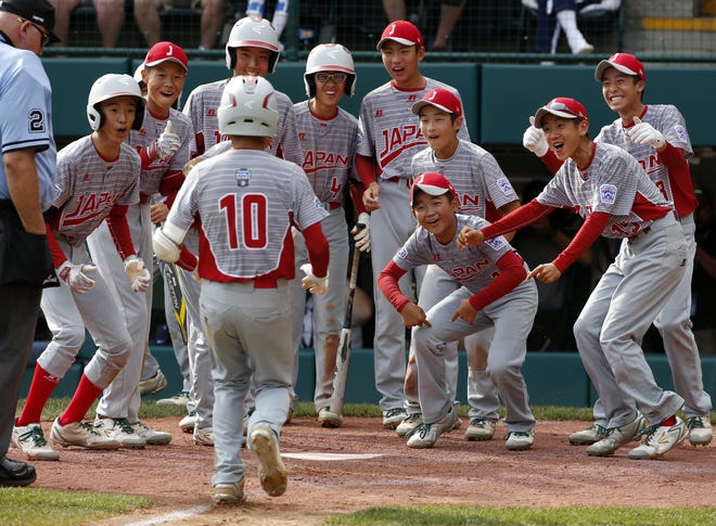 Japan's Keitaro Miyahara (10) is greeted by teammates after hitting a solo home run off Lufkin, Texas' Chip Buchanan in the fourth inning of the Little League World Series Championship baseball game in South Williamsport, Pa., Sunday, Aug. 27, 2017. (AP Photo/Gene J. Puskar).