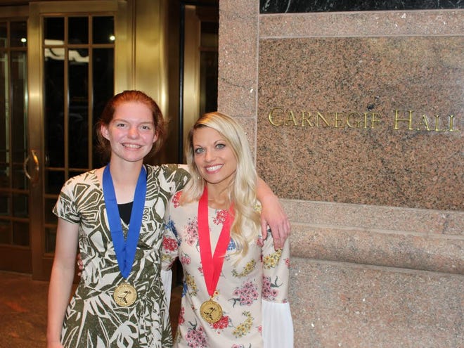 Zeeland East fresman Bethany Colbrunn, left, with her art teacher Michelle Fuller at New York City's Carnegie Hall. Colbrunn went to New York to accept a national gold medal for her artwork in the Scholastic Art and Writing Awards. [Contributed]