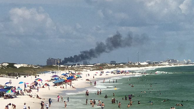Smoke wafts over Crab Island after a boat fire Sunday afternoon. [ANNIE BLANKS/DAILY NEWS]