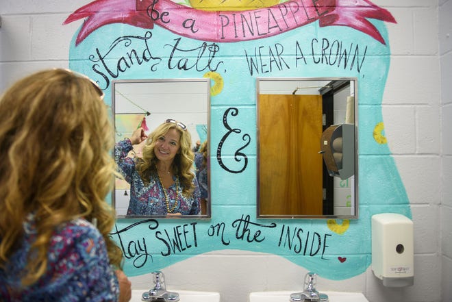 Shari Jackson Link, a local artist, painted encouraging quotes in the girls restrooms of Fayetteville Academy. There are plans to add similar renderings in the boys restrooms. [Michael Futch/The Fayetteville Observer]