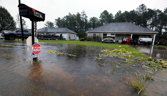 Rising waters threaten homes along North Perkins Ferry Road in Moss Bluff, La., near Lake Charles, La., as a constant rain from Tropical Storm Harvey falls, Monday, Aug. 28, 2017. (AP Photo/Rogelio V. Solis)