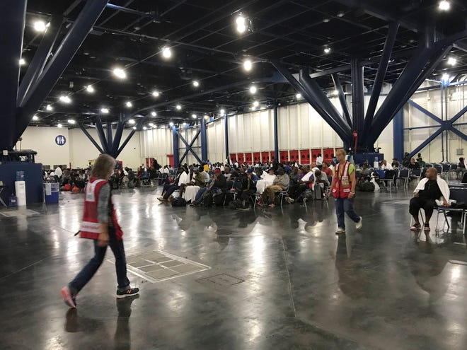 People seek shelter from the aftermath of Hurricane Harvey at the George R. Brown Convention Center in Houston on Sunday, Aug. 27, 2017. Rising floodwaters from the remnants of Hurricane Harvey chased thousands of people to rooftops or higher ground Sunday in Houston, overwhelming rescuers who fielded countless desperate calls for help. (Elizabeth Conley/Houston Chronicle via AP)