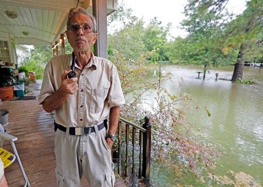 Jimmie Bradley speaks about the flooding in his neighborhood in Moss Bluff, a Lake Charles, La., suburb in Calcasieu Parish, Monday, Aug. 28, 2017. Bradley, 78, and his wife Brenda, had stacked sandbags at their doors, but the rising water was lapping at the steps to their back porch and had overtaken their front yard. Virtually every neighbor on Crawford Drive has at least a foot of water in their yards. (AP Photo/Rogelio V. Solis)